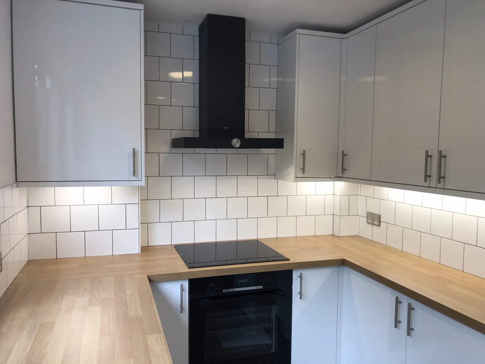 Kitchen with under-cabinet lighting and sockets fitted by Langley Electrical Contractors